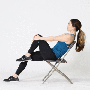 Woman sitting on chair performing hip and knee flexion stretch