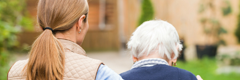 Counselor supporting an elderly woman suffering from alzheimer's.