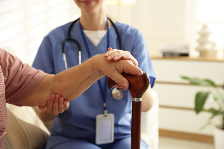 In home care caregiver supporting senior woman